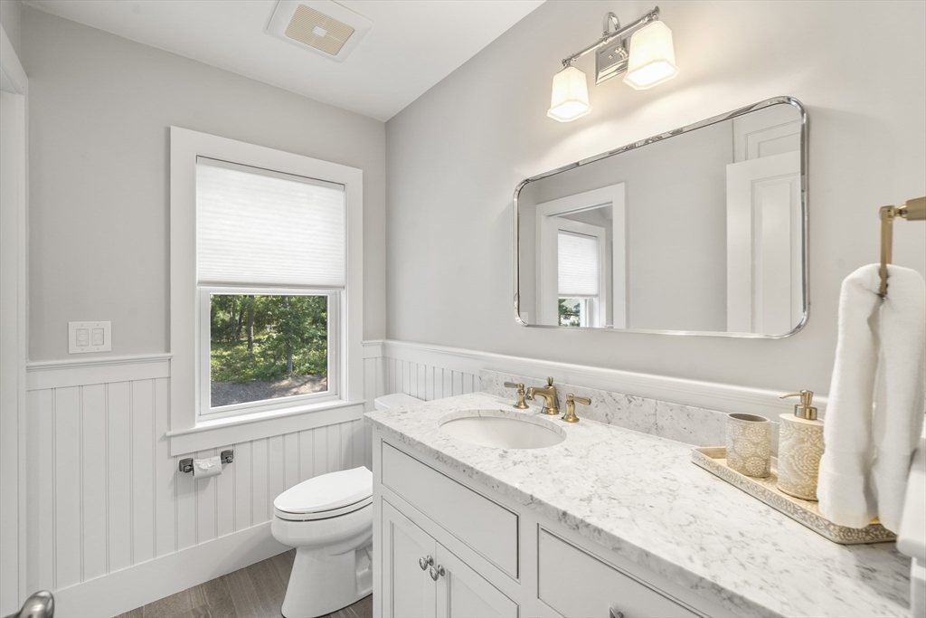 3 Bascom Hollow Harwich, MA 02645 - Photo 22 of 32 a bathroom with a granite countertop sink toilet and mirror