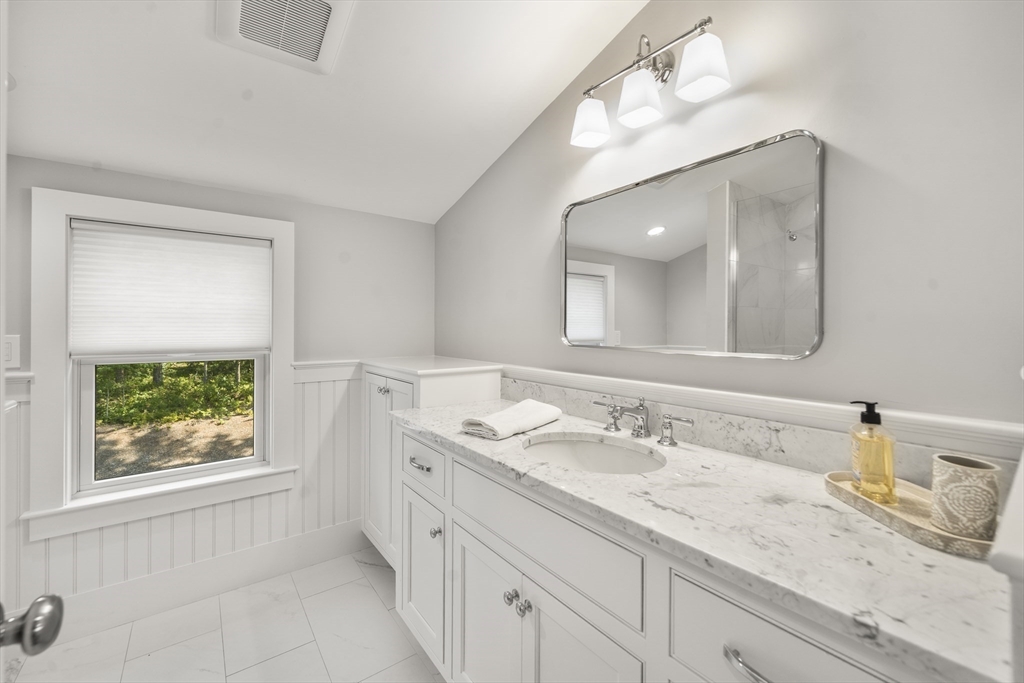 3 Bascom Hollow Harwich, MA 02645 - Photo 27 of 32 a bathroom with a granite countertop sink a large mirror and a window