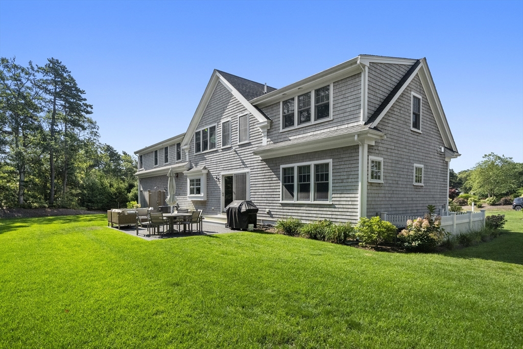 3 Bascom Hollow Harwich, MA 02645 - Photo 30 of 32 a front view of a house with a yard and trees