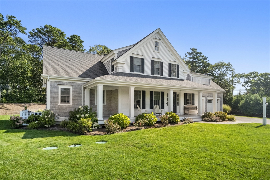3 Bascom Hollow Harwich, MA 02645 - Photo 3 of 32 a front view of house with yard outdoor seating and green space