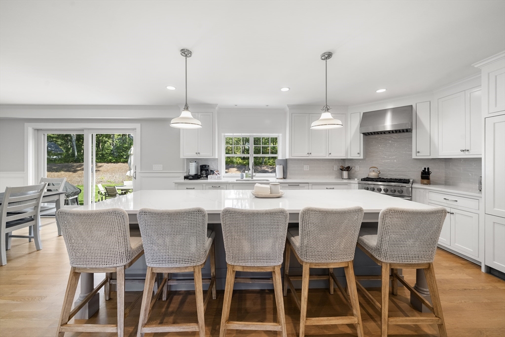3 Bascom Hollow Harwich, MA 02645 - Photo 4 of 32 a kitchen with a dining table chairs and white cabinets