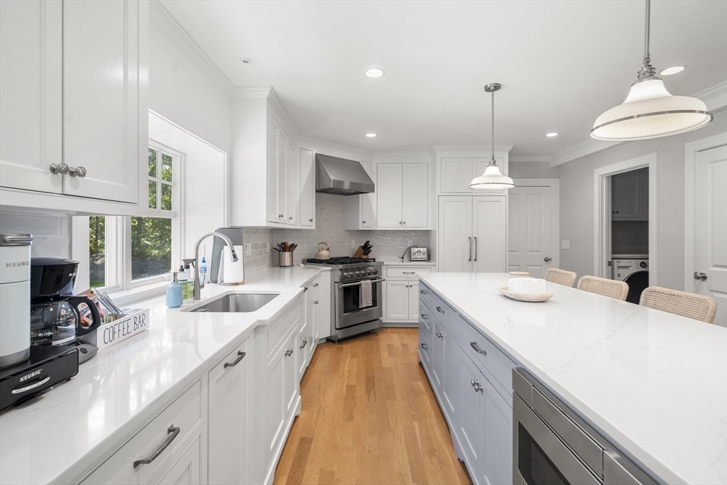 3 Bascom Hollow Harwich, MA 02645 - Photo 7 of 32 a large kitchen with kitchen island a large counter space a sink appliances and cabinets