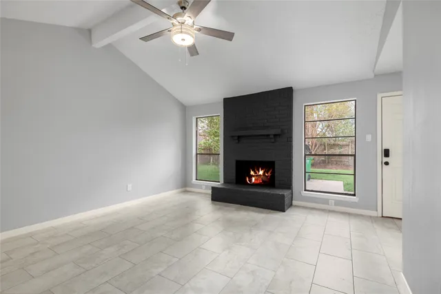 a view of an empty room with a fireplace