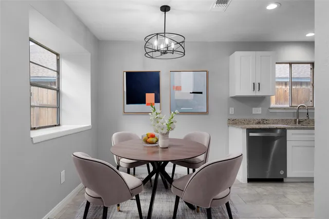 a kitchen with stainless steel appliances granite countertop a refrigerator a stove top oven a sink and dishwasher