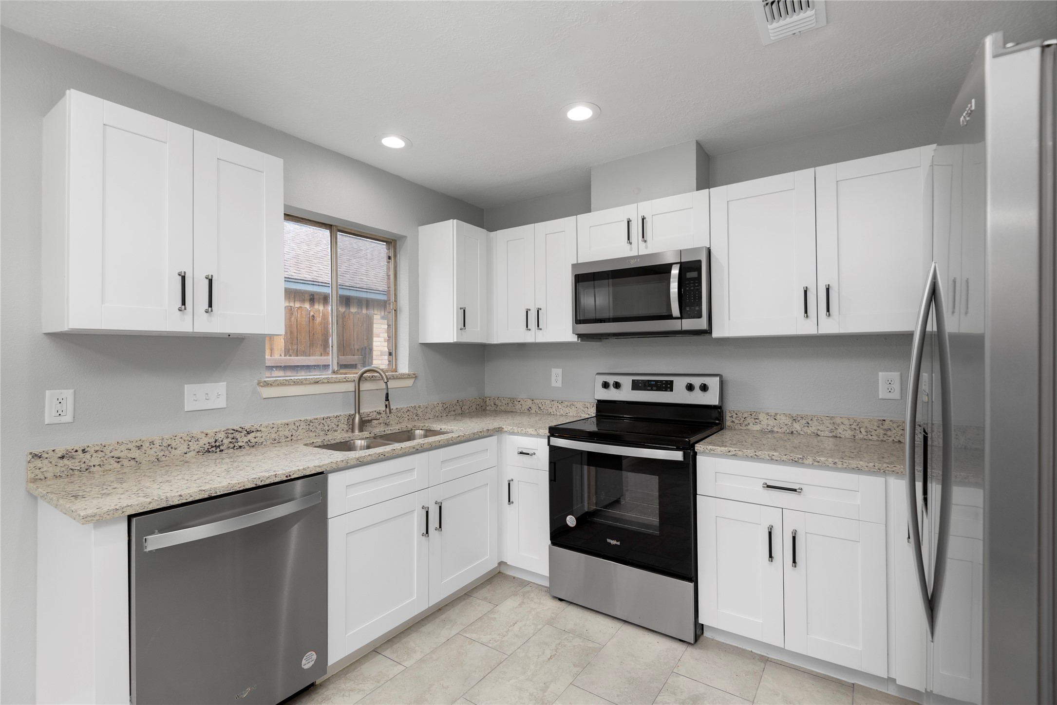 4919 Tealgate Drive Spring, TX 77373 - Photo 17 of 38 a kitchen with white cabinets sink and stainless steel appliances
