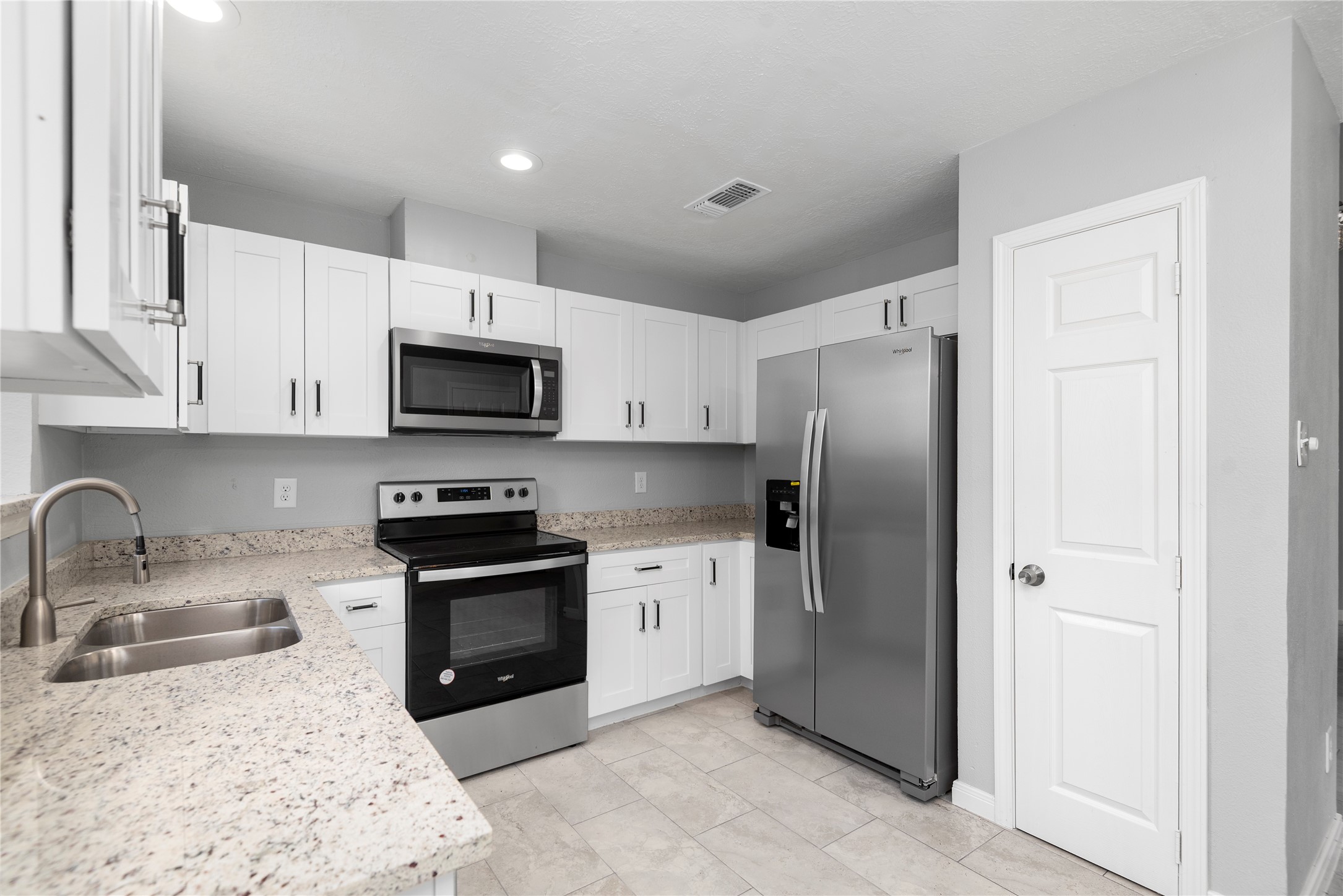 4919 Tealgate Drive Spring, TX 77373 - Photo 18 of 38 a kitchen with stainless steel appliances granite countertop a refrigerator stove and sink