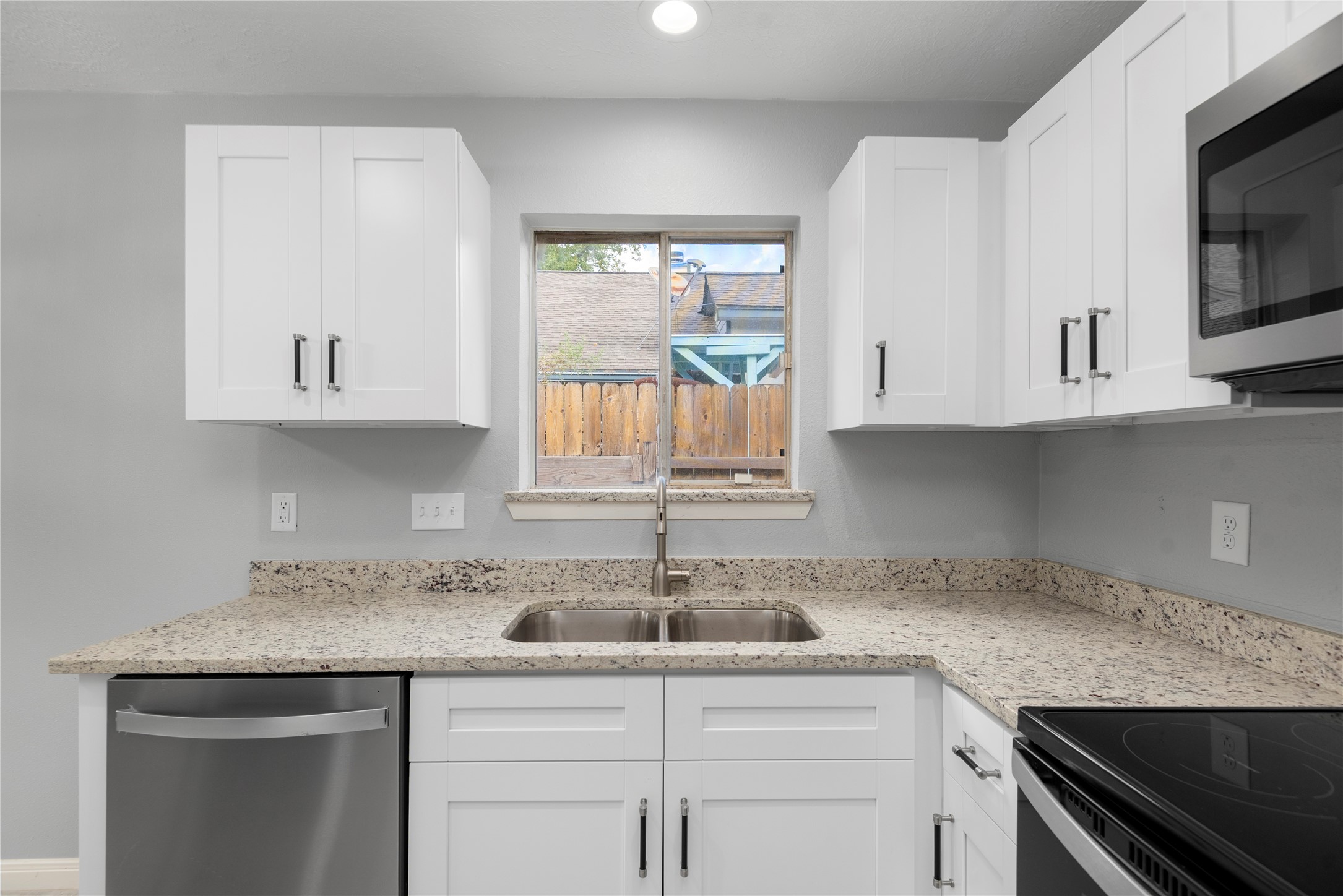 4919 Tealgate Drive Spring, TX 77373 - Photo 19 of 38 a kitchen with stainless steel appliances granite countertop a sink and a microwave