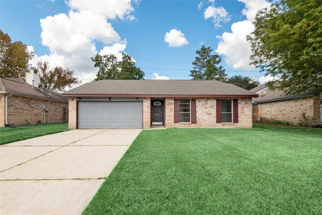 a front view of a house with a garden and yard