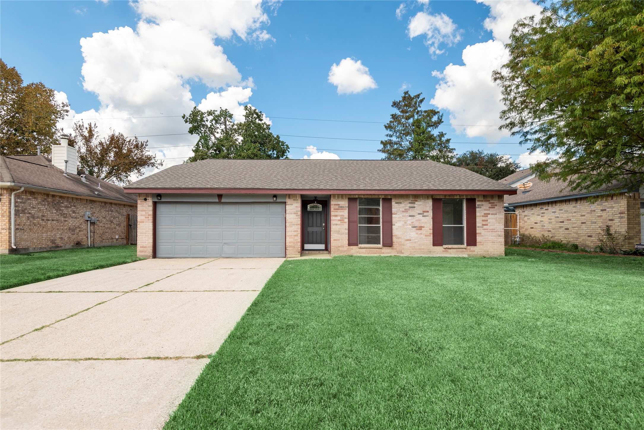 4919 Tealgate Drive Spring, TX 77373 - Photo 2 of 38 a front view of a house with a garden and yard