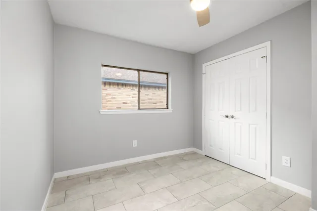 a bathroom with a granite countertop sink a mirror and a bathtub