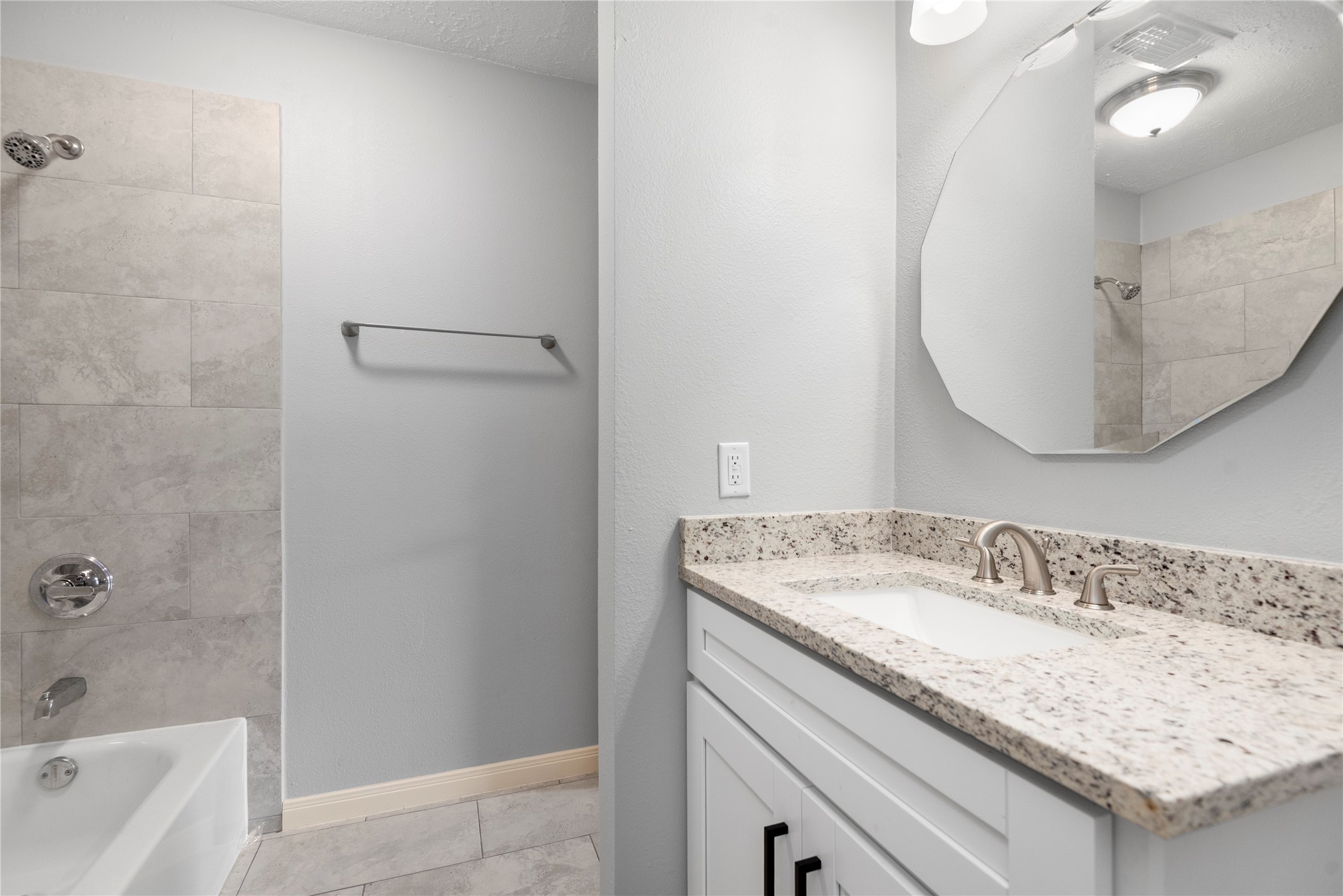 4919 Tealgate Drive Spring, TX 77373 - Photo 31 of 38 a bathroom with a granite countertop sink a mirror and a bathtub