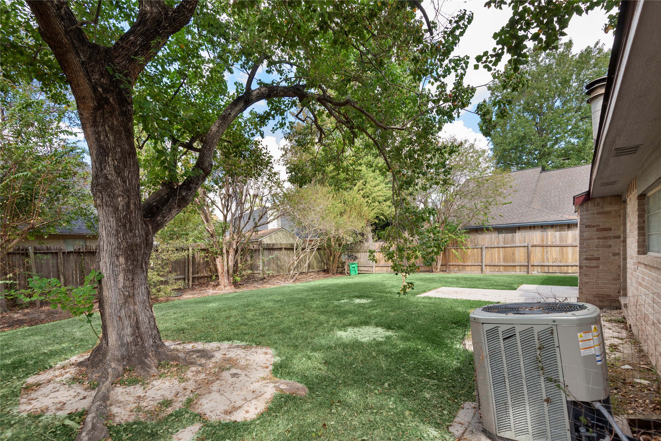 4919 Tealgate Drive Spring, TX 77373 - Photo 36 of 38 a backyard of a house with lots of green space and fountain