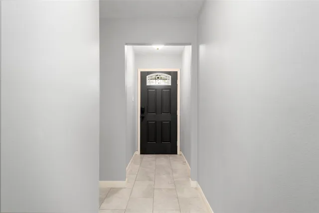 a view of an empty room with a fireplace and a window