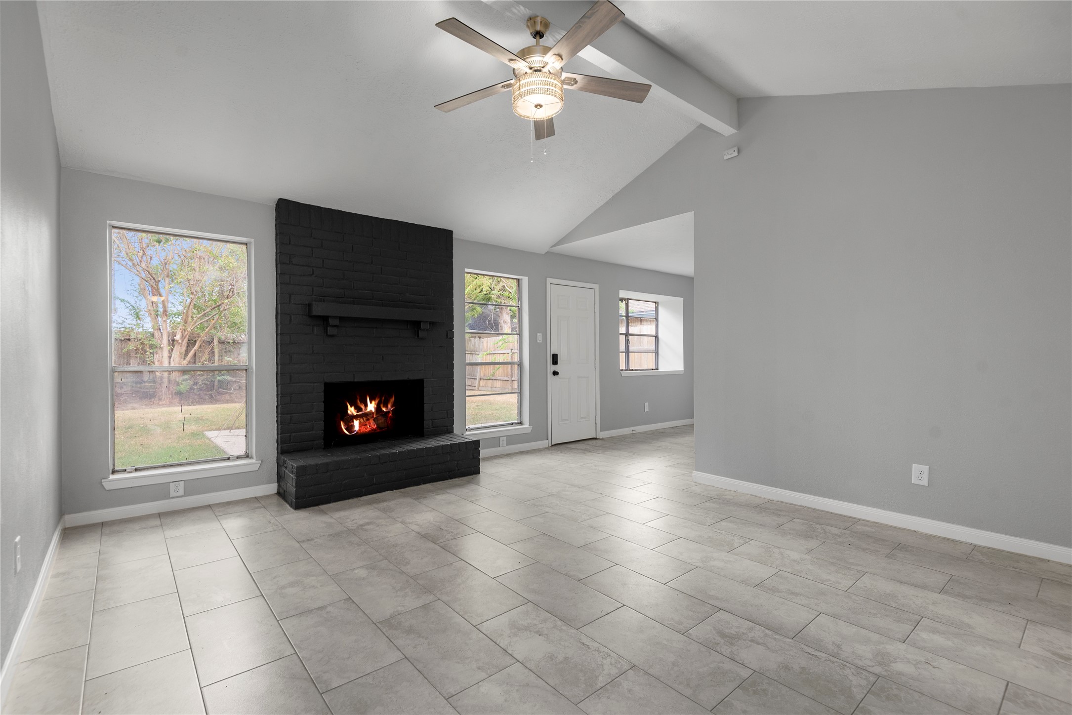 4919 Tealgate Drive Spring, TX 77373 - Photo 8 of 38 a view of an empty room with a fireplace and a window