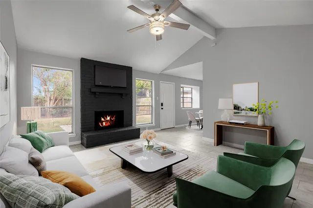 a view of an empty room with a fireplace and window