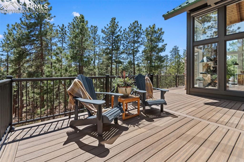 5090 South Perry Park Road Sedalia, CO 80135 - Photo 19 of 50 a view of a roof deck with wooden floor and fence