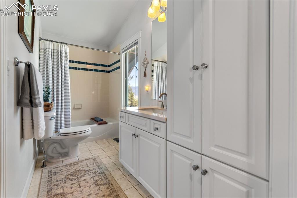5090 South Perry Park Road Sedalia, CO 80135 - Photo 28 of 50 a bathroom with a shower sink and mirror