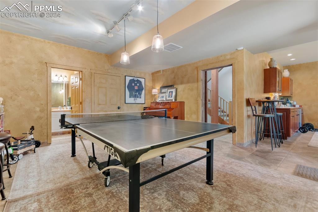 5090 South Perry Park Road Sedalia, CO 80135 - Photo 32 of 50 a room with table chairs and flat screen tv