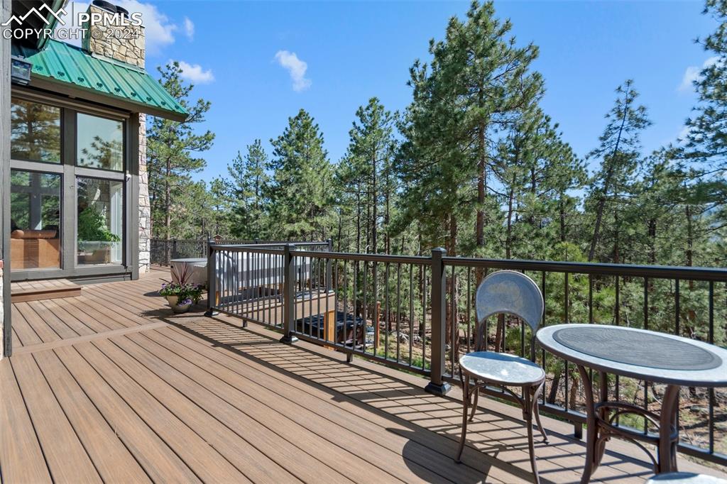 5090 South Perry Park Road Sedalia, CO 80135 - Photo 39 of 50 a balcony with wooden floor table and chairs
