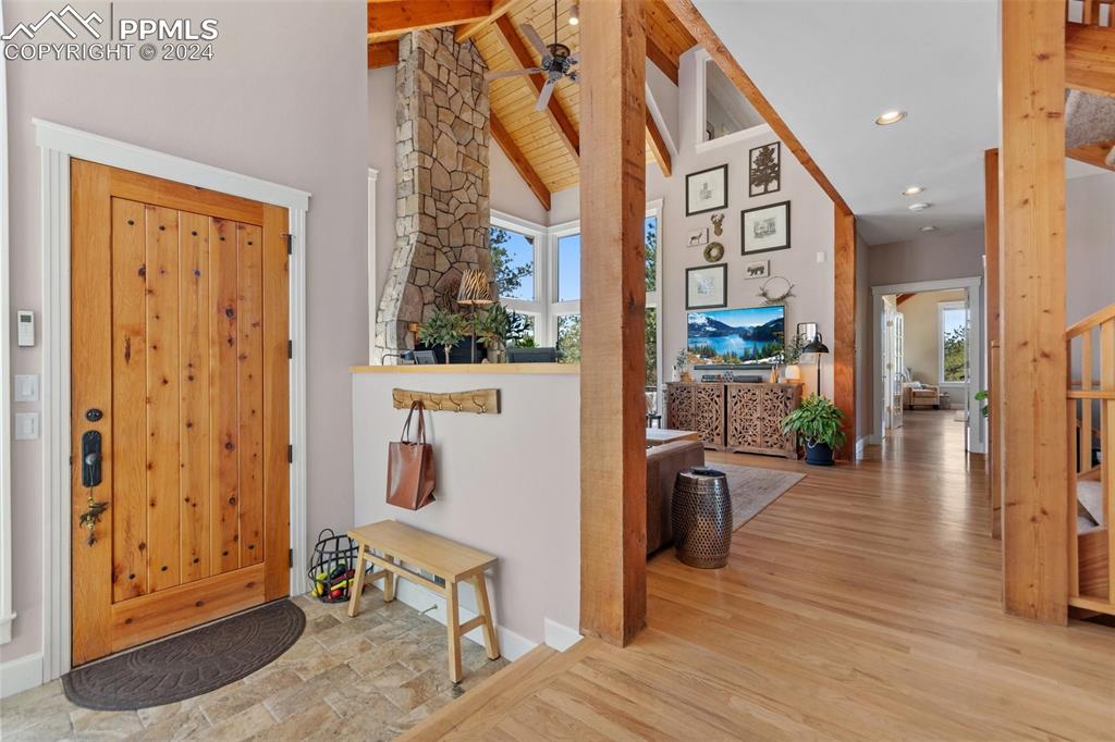 5090 South Perry Park Road Sedalia, CO 80135 - Photo 4 of 50 a view of a hallway with wooden floor and windows