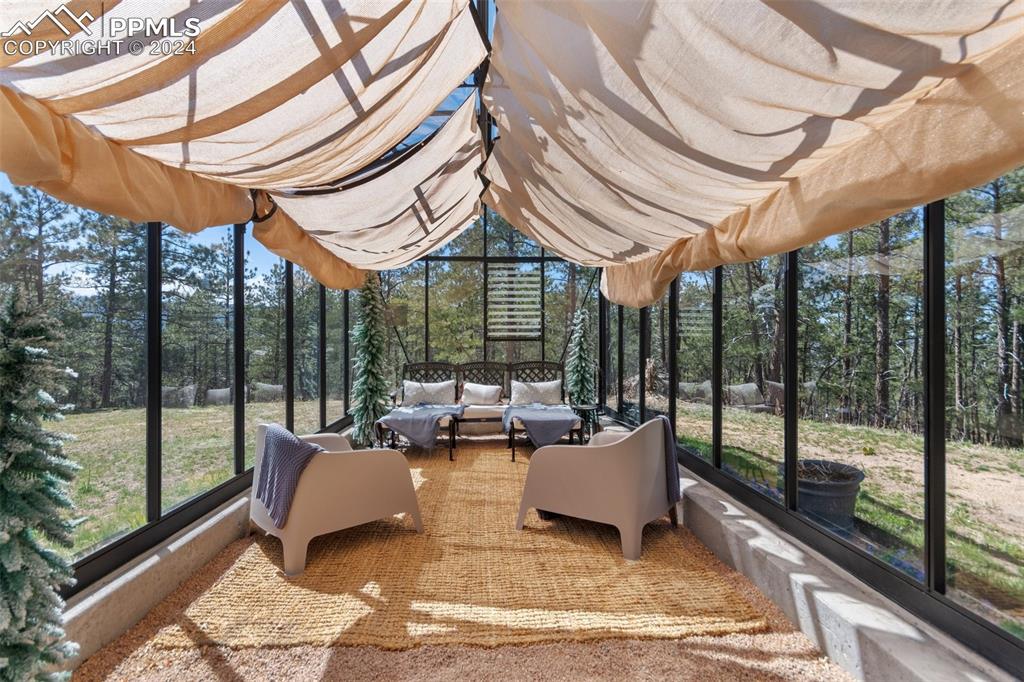 5090 South Perry Park Road Sedalia, CO 80135 - Photo 41 of 50 a living room with furniture and a floor to ceiling window