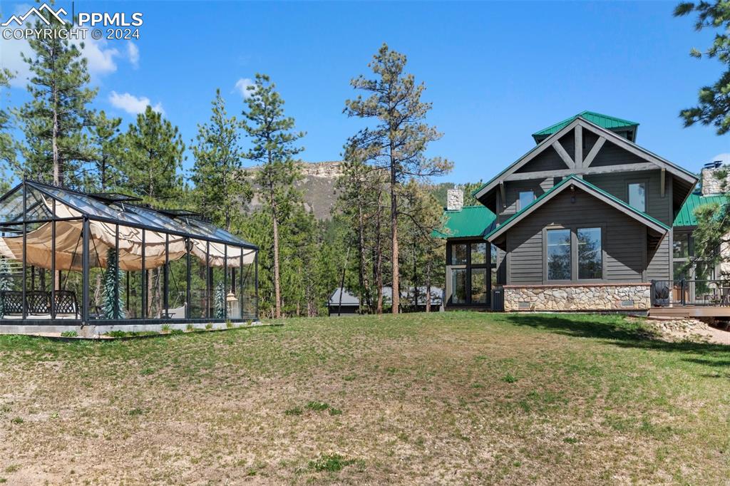 5090 South Perry Park Road Sedalia, CO 80135 - Photo 42 of 50 a front view of a house with a yard