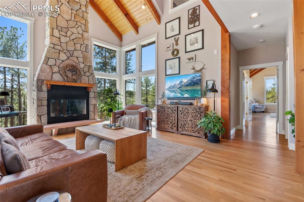 5090 South Perry Park Road Sedalia, CO 80135 - Photo 5 of 50 a living room with furniture large window and wooden floor