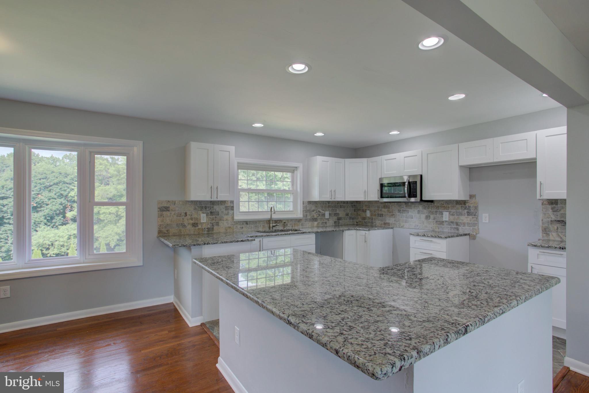 1229 Rawlinsville Road New Providence, PA 17560 - Photo 12 of 29 a large kitchen with kitchen island a large counter top and a sink