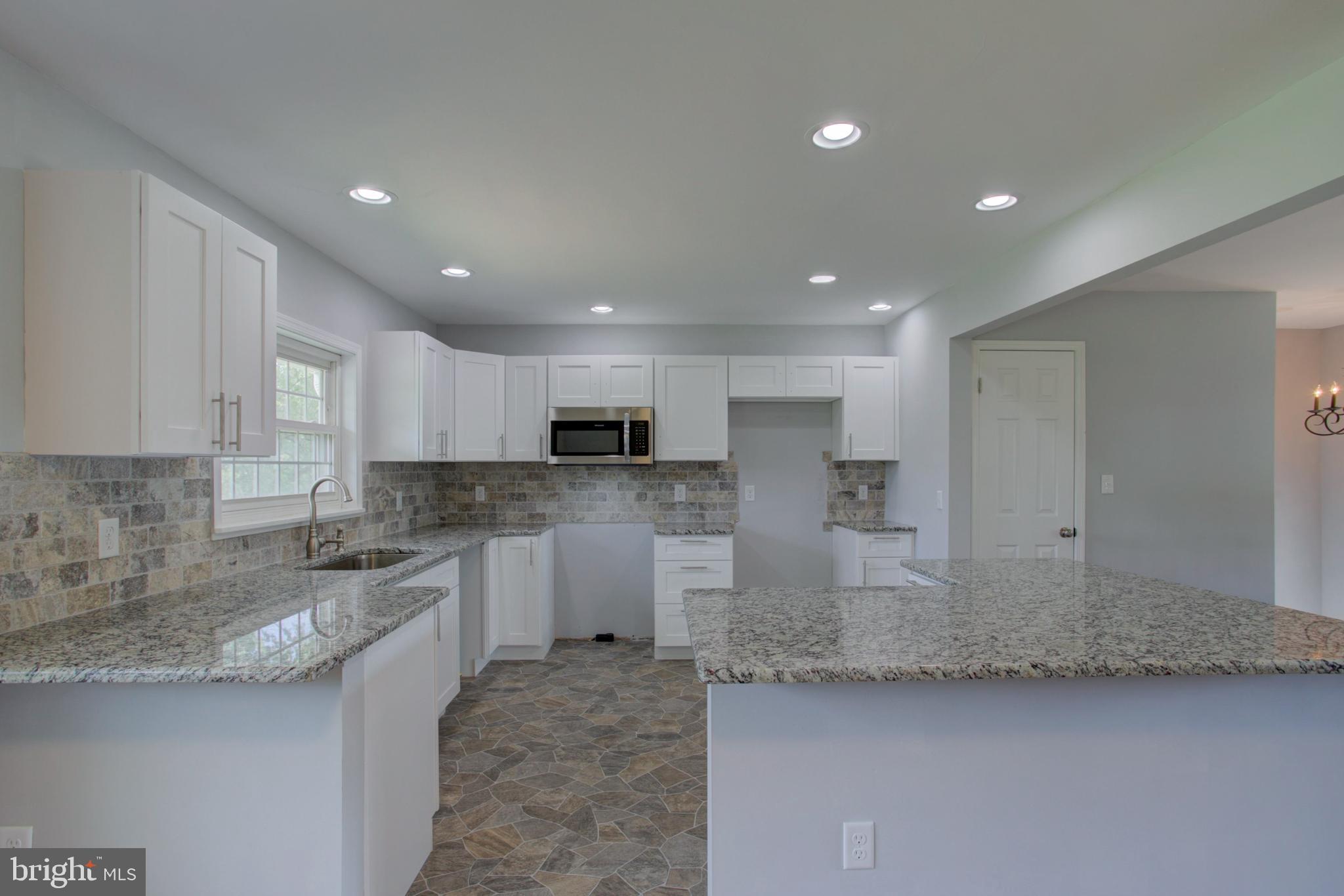 1229 Rawlinsville Road New Providence, PA 17560 - Photo 13 of 29 a kitchen with stainless steel appliances granite countertop a sink and cabinets