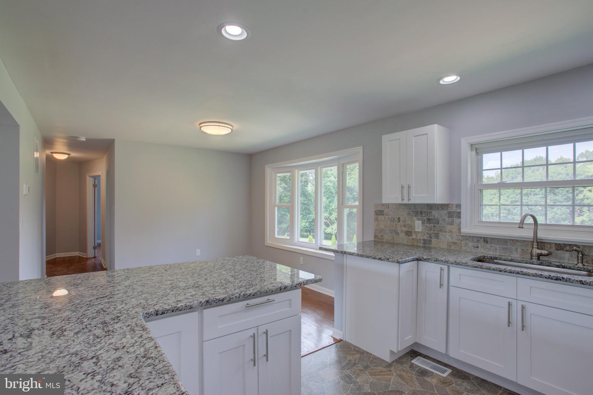 1229 Rawlinsville Road New Providence, PA 17560 - Photo 15 of 29 a kitchen with granite countertop a sink window and cabinets