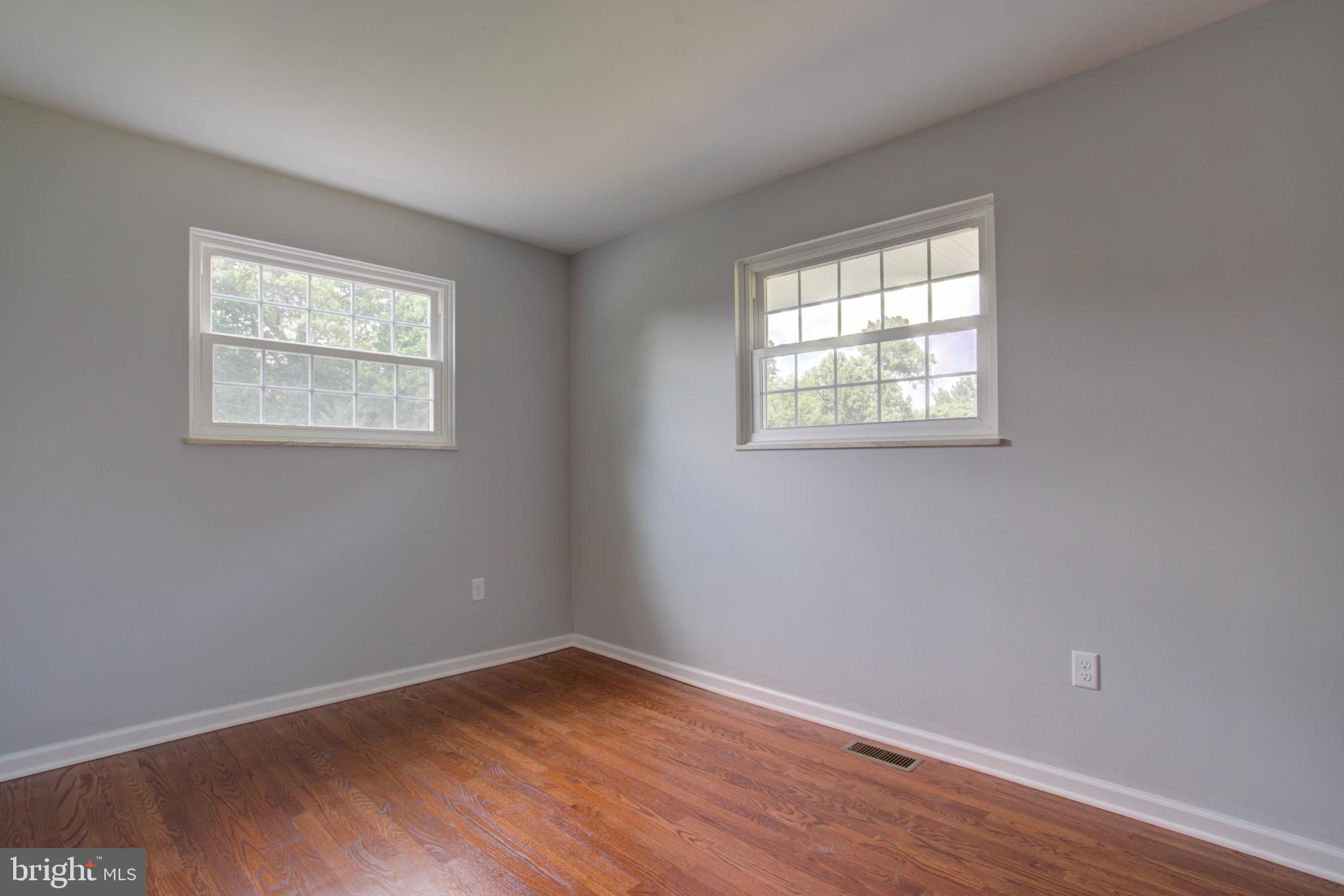 1229 Rawlinsville Road New Providence, PA 17560 - Photo 21 of 29 a view of an empty room with wooden floor and a window