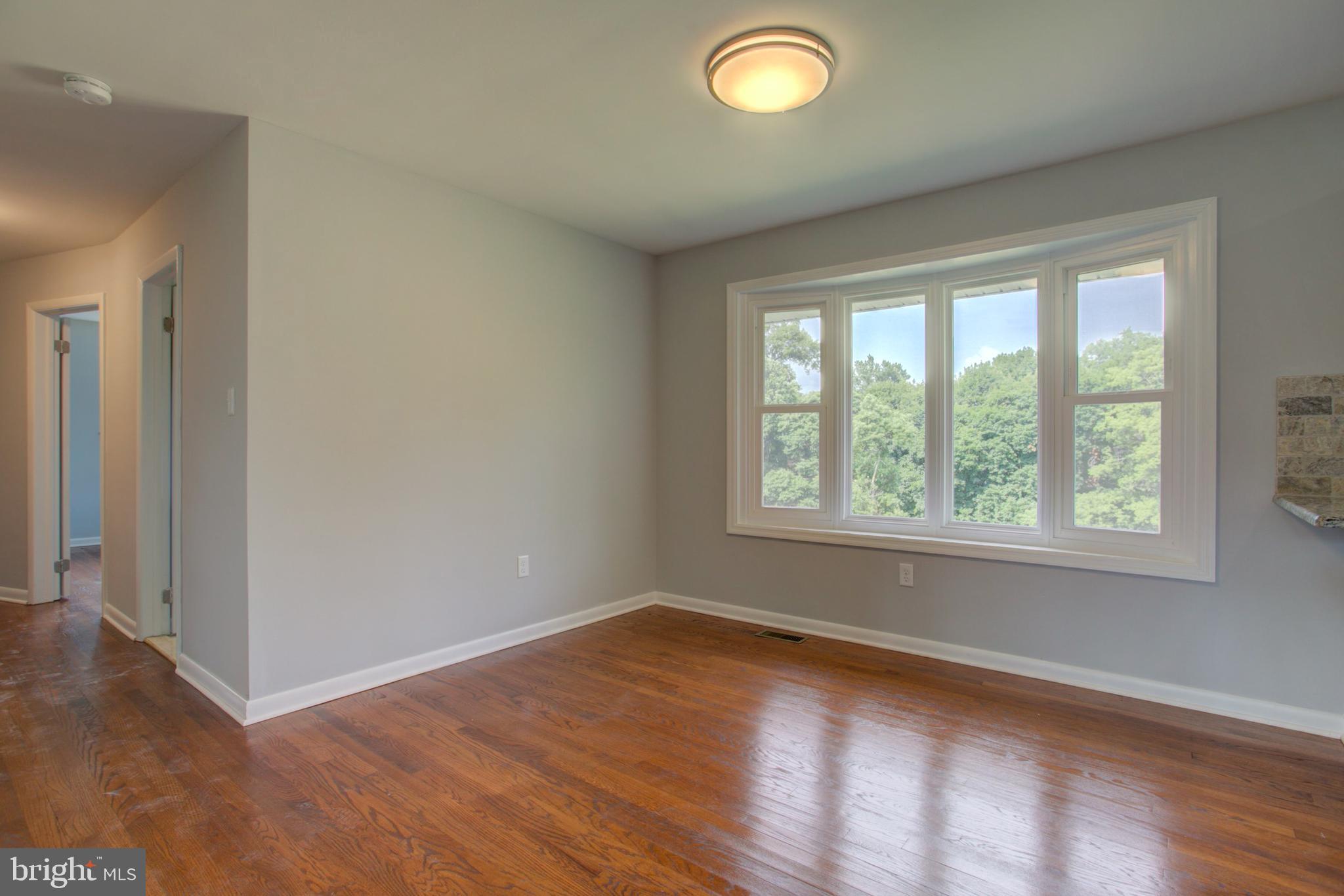 1229 Rawlinsville Road New Providence, PA 17560 - Photo 24 of 29 an empty room with wooden floor and windows