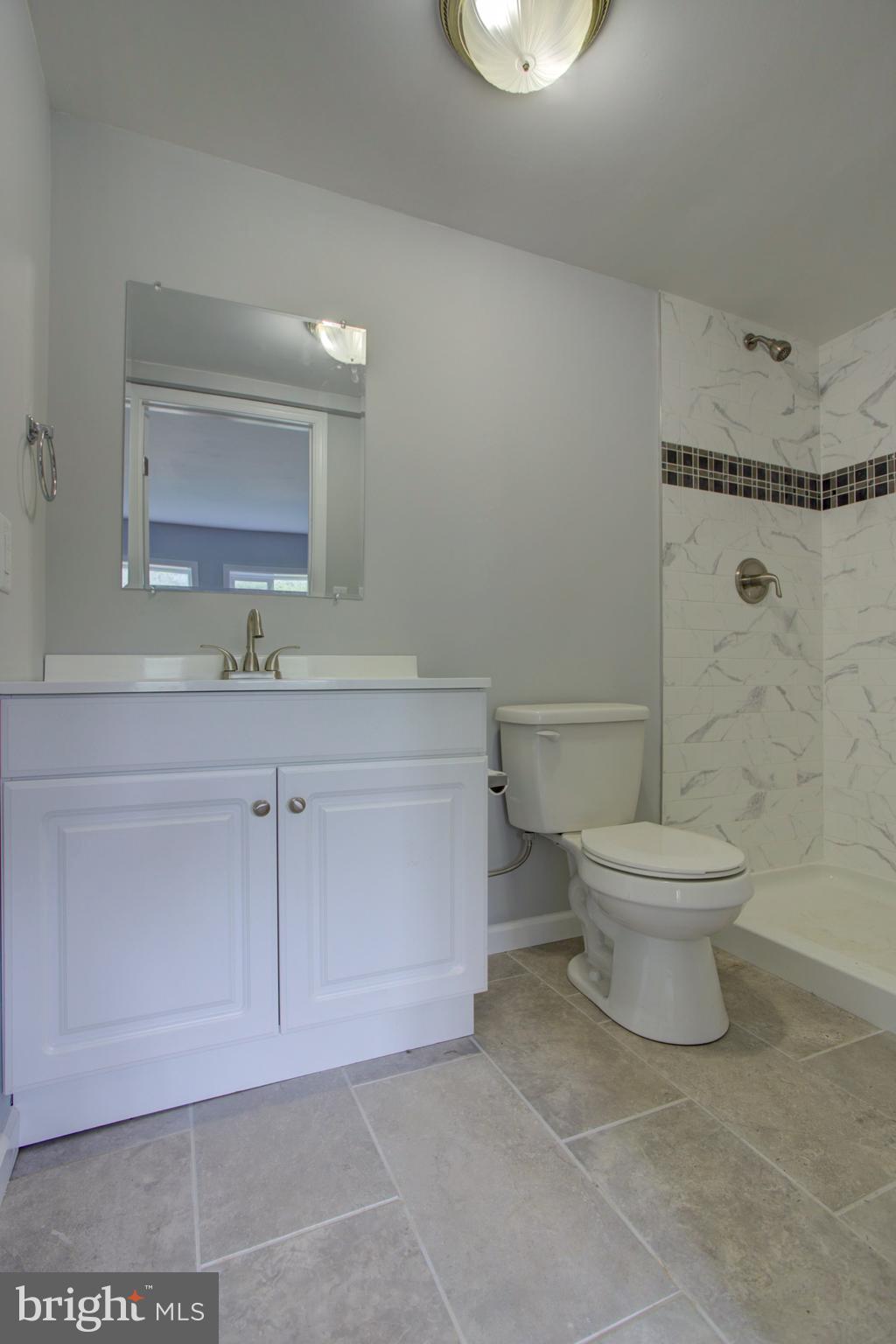 1229 Rawlinsville Road New Providence, PA 17560 - Photo 28 of 29 a bathroom with a toilet a sink and mirror
