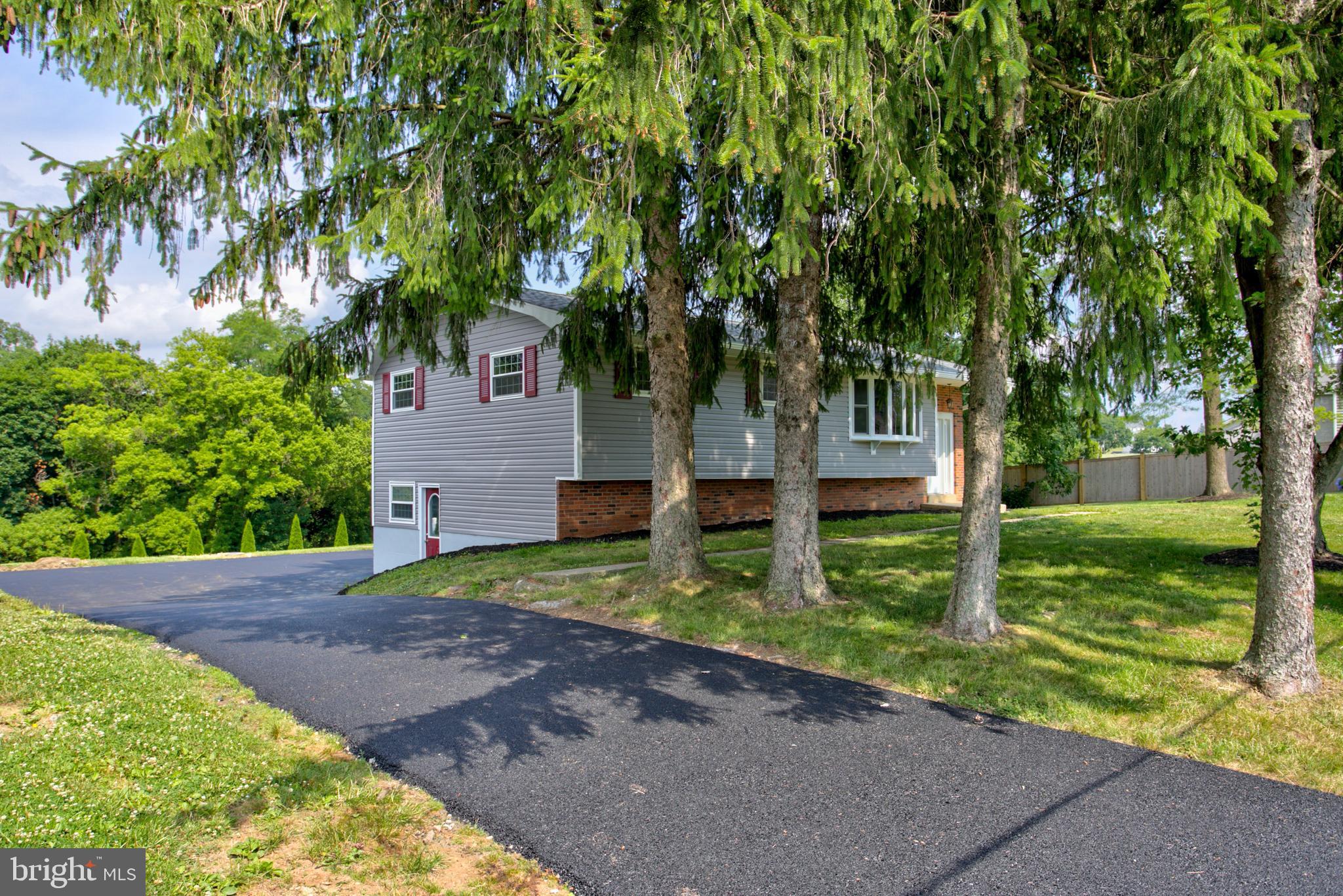 1229 Rawlinsville Road New Providence, PA 17560 - Photo 5 of 29 a front view of a house with a yard and a large tree
