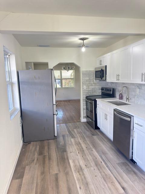 1709 North J Street Lake Worth Beach, FL 33460 - Photo 5 of 10 a kitchen with stainless steel appliances a refrigerator sink and stove