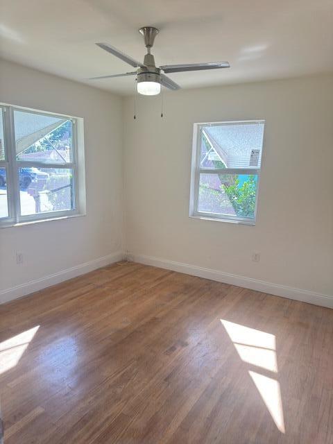 1709 North J Street Lake Worth Beach, FL 33460 - Photo 6 of 10 a view of an empty room with wooden floor and window