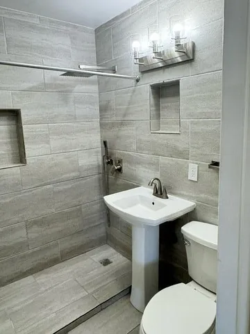 a bathroom with a sink toilet and shower