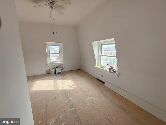 a living room with furniture and a ceiling fan