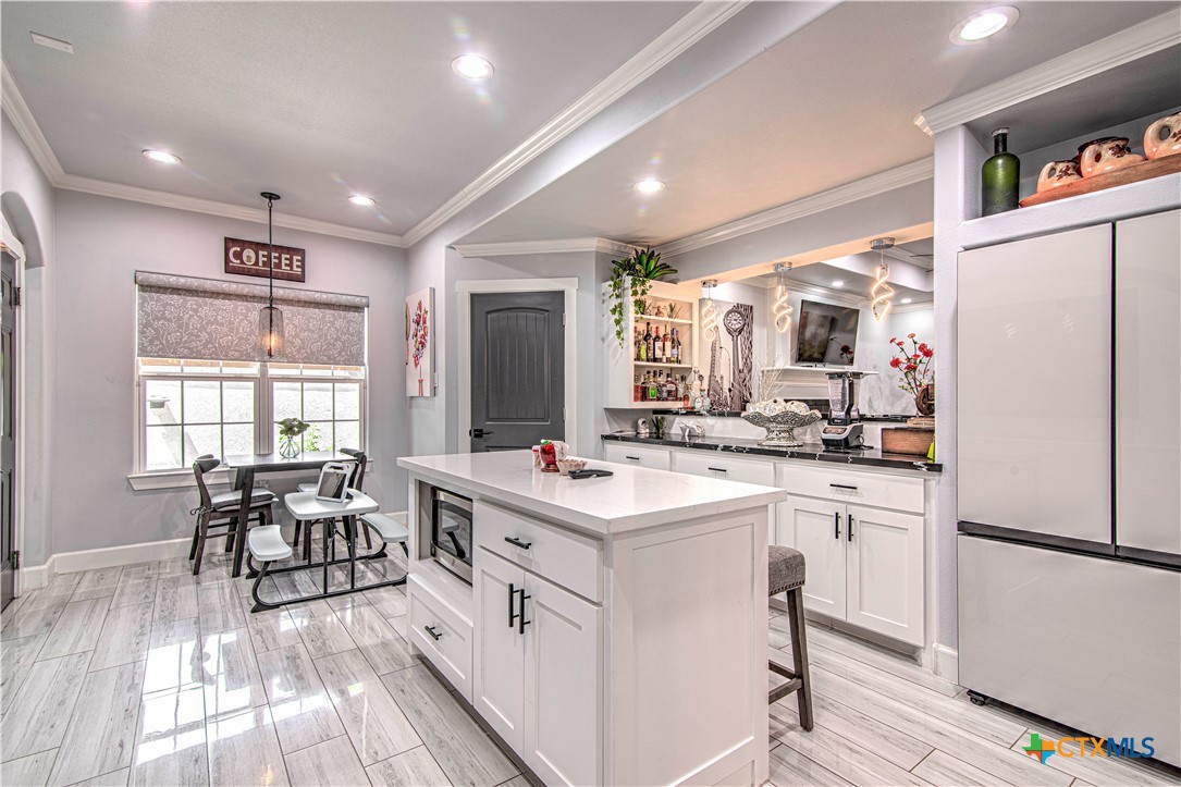 10 West Zenith Avenue Temple, TX 76501 - Photo 11 of 48 a kitchen with white cabinets and white appliances