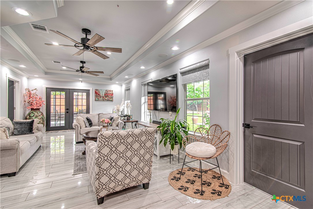 10 West Zenith Avenue Temple, TX 76501 - Photo 20 of 48 a living room with furniture a dining table and a chandelier