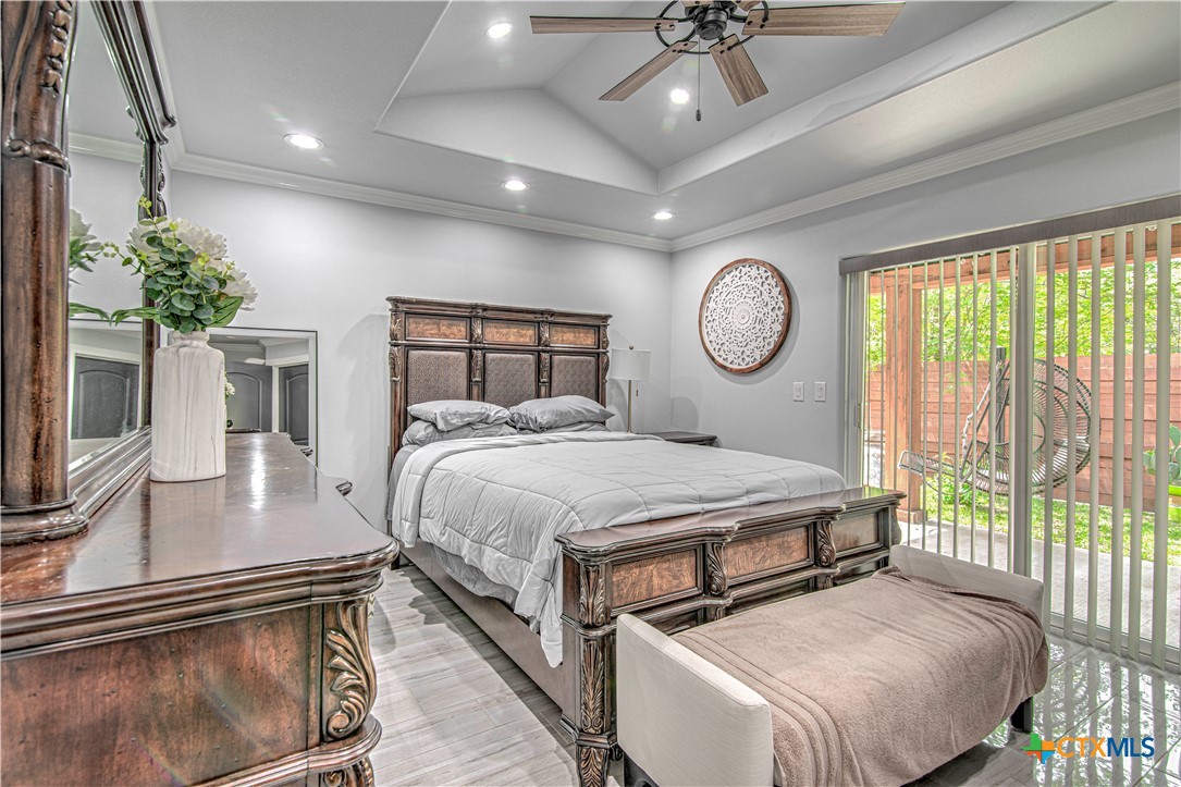 10 West Zenith Avenue Temple, TX 76501 - Photo 24 of 48 a bedroom with a large bed and a chandelier
