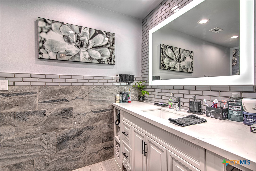10 West Zenith Avenue Temple, TX 76501 - Photo 26 of 48 a bathroom with a sink and a mirror