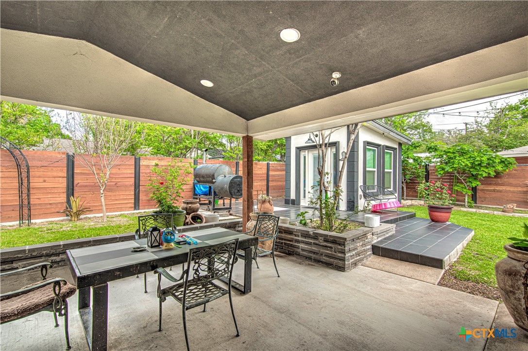 10 West Zenith Avenue Temple, TX 76501 - Photo 39 of 48 a living room with patio furniture and a floor to ceiling window