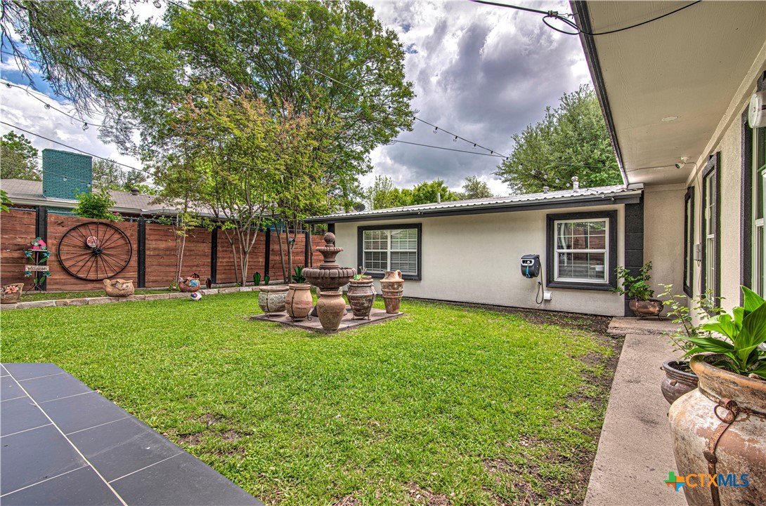 10 West Zenith Avenue Temple, TX 76501 - Photo 41 of 48 a view of a house with backyard sitting area and garden