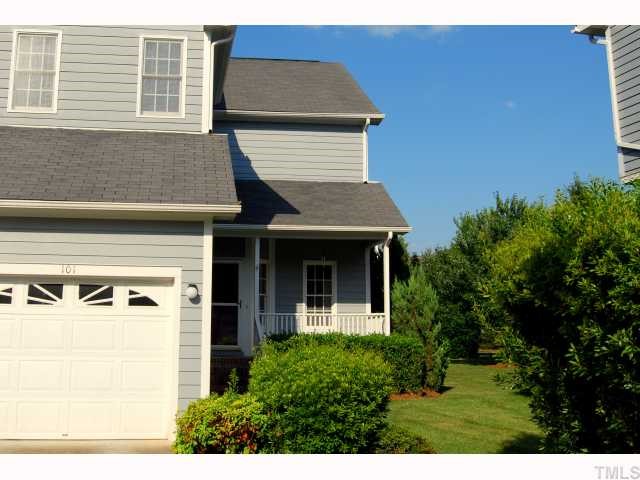 8320 Hempshire Place, Unit 101 Raleigh, NC 27613 - Photo 1 of 12 a view of a house with potted plants and a large tree