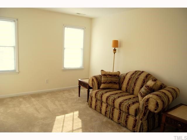 8320 Hempshire Place, Unit 101 Raleigh, NC 27613 - Photo 11 of 12 a living room with a couch and a table