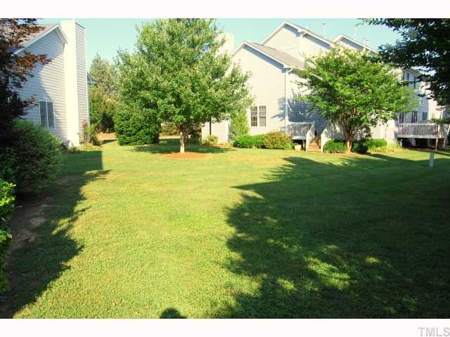 8320 Hempshire Place, Unit 101 Raleigh, NC 27613 - Photo 2 of 12 a view of an outdoor space and a yard