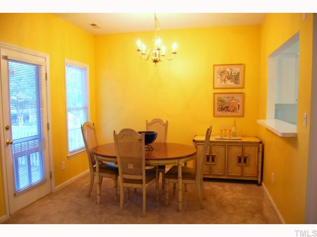 8320 Hempshire Place, Unit 101 Raleigh, NC 27613 - Photo 3 of 12 a dining room with furniture and a chandelier