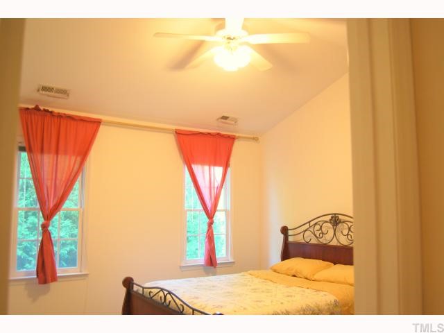 8320 Hempshire Place, Unit 101 Raleigh, NC 27613 - Photo 7 of 12 a bedroom with a bed and a window with outer view