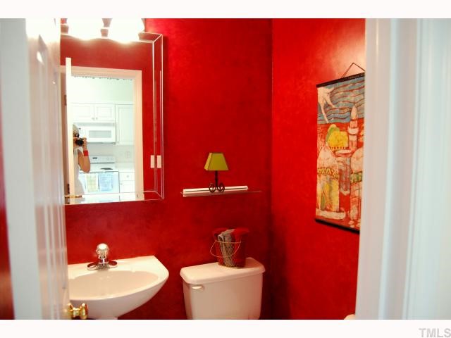 8320 Hempshire Place, Unit 101 Raleigh, NC 27613 - Photo 9 of 12 a bathroom with a sink and a mirror